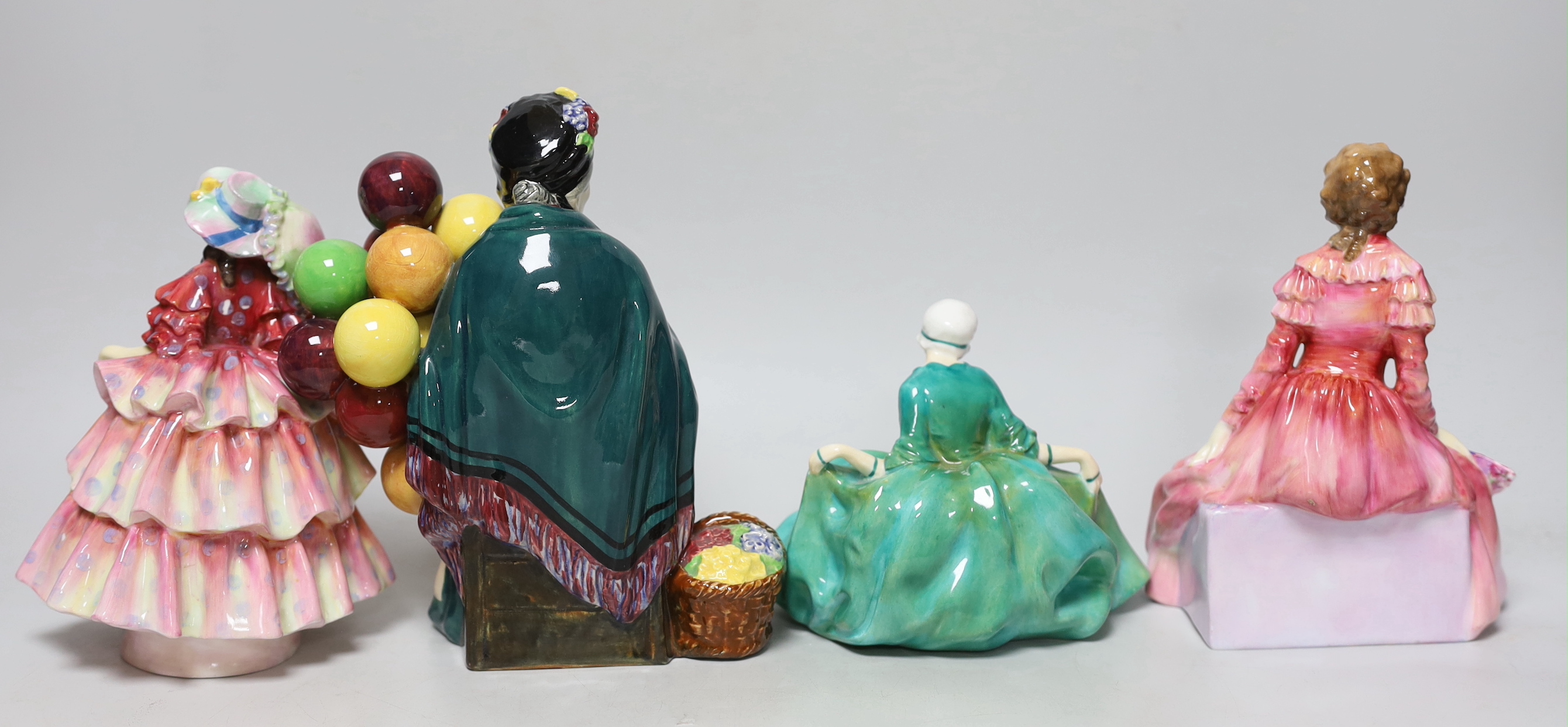 Four Royal Doulton figurines comprising Polly Peachum, Parasol, Charmian and Balloon seller, the largest 19cm high